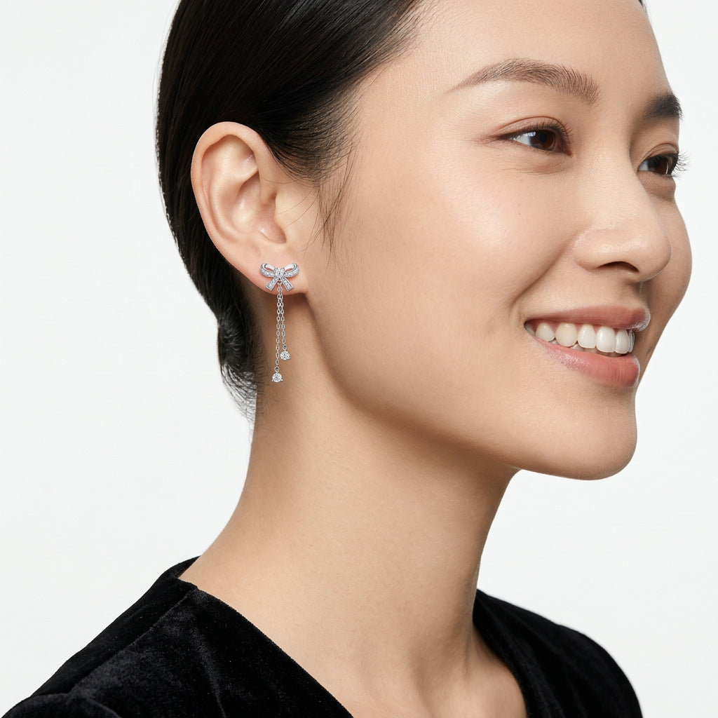 VANLARA bow tassel moissanite earrings worn on ear side view