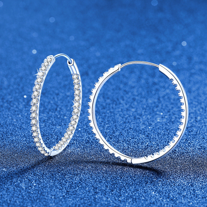 VANLARA moissanite big hoop earrings on blue background
