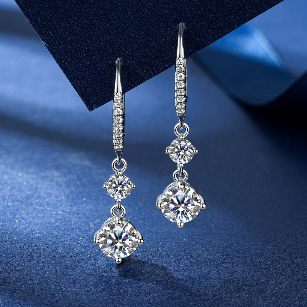 VANLARA double stone moissanite tassel earrings on deep blue background